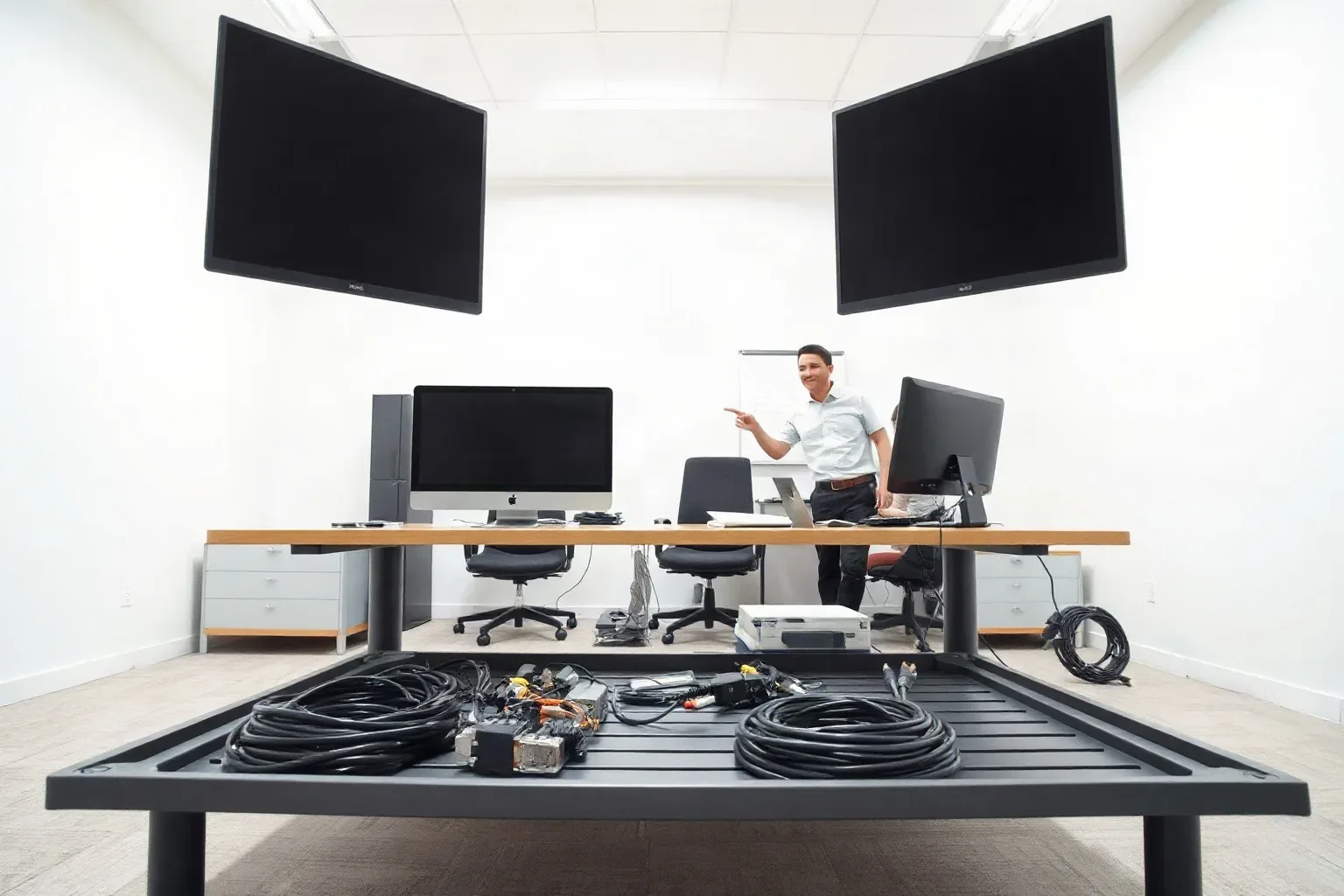 A neat cable tray beneath a standing desk with bundled leads and power strips