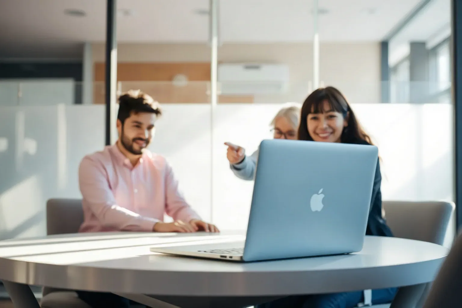 A laptop open at a shallow angle on a meeting table